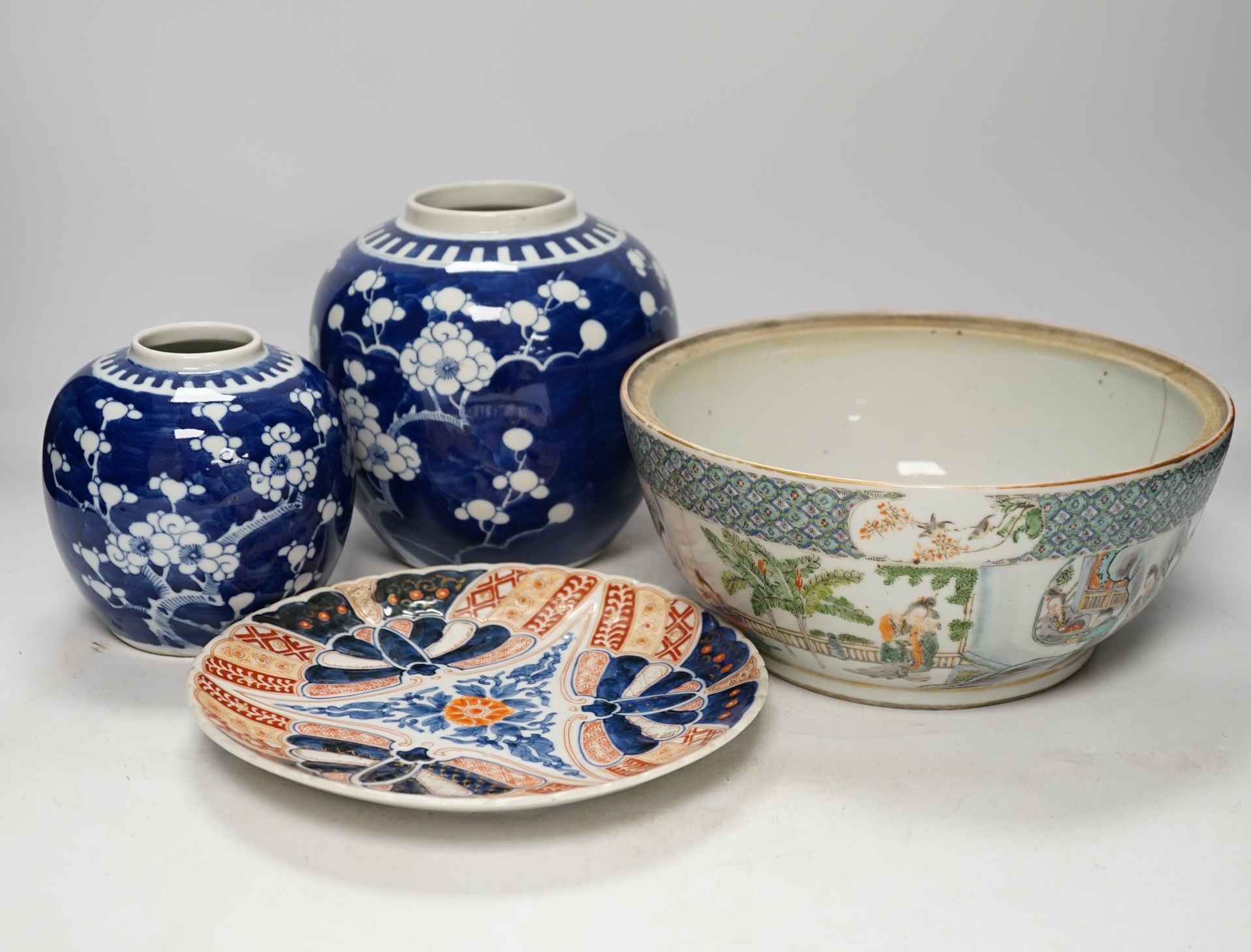 A 19th century Chinese famille verte handled bowl, missing cover, two blue and white prunus jars and an Imari dish, largest 28cm long. Condition - poor to fair